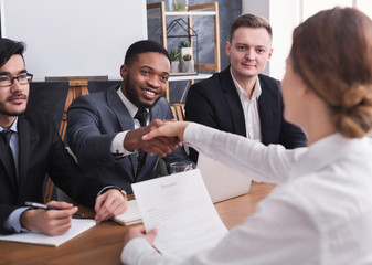 HR manager shaking hands with female applicant