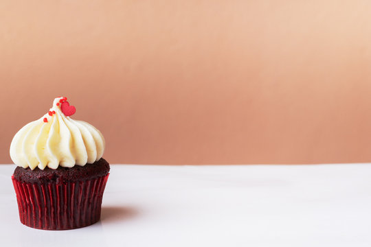 Cute little red heart on white cream cupcake, sweet dessert concept