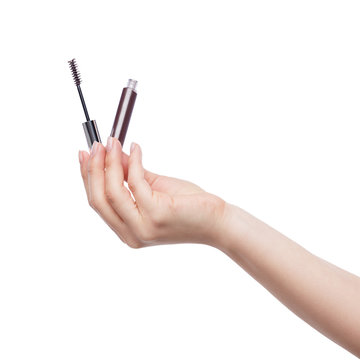Woman hand with mascara cosmetic tube isolated