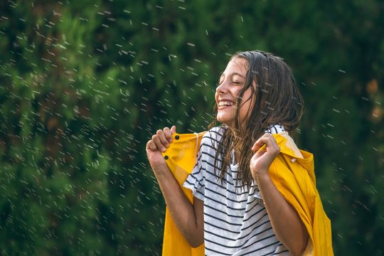 Girl Wearing Yellow Rain Coat Out In The Rain