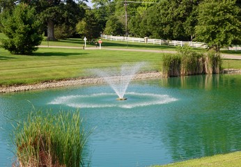 A beautiful view of the fountain in the park on a sunny day.