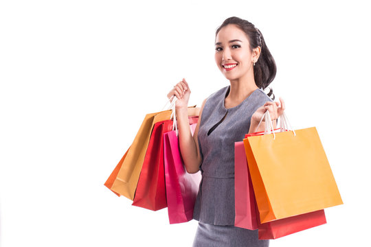 Beautiful Attractive Asian Woman smile and holding shopping bags feeling so happiness and enjoy with black Friday sale in Shopping mall,isolated on white background,Shopping Concept
