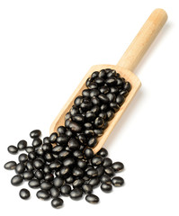 raw black bean in the wooden scoop, isolated on white