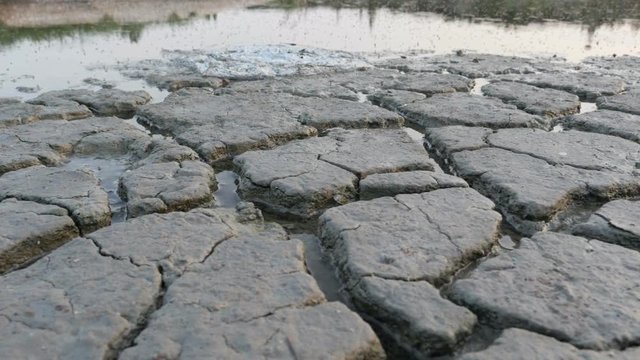 Cracked ground of the polluted lake.  Concept: climate change, global warming, drought, weather, polluted environment
