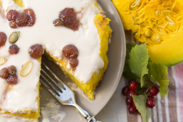 Pumpkin homemade cheesecake with white cream. Autumn still life. Thanksgiving day food.