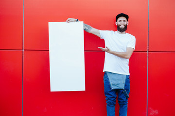 Hipster man holding a poster