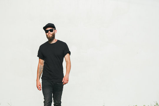 Hipster handsome male model with beard wearing black blank t-shirt