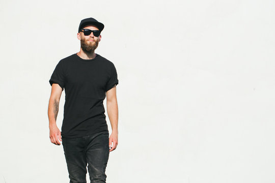 Hipster handsome male model with beard wearing black blank t-shirt