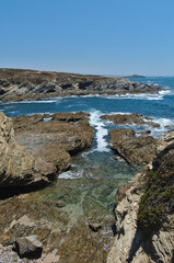 Fototapeta na wymiar Pessegueiro Island, rocks and cliffs in Porto Covo. Alentejo, Portugal