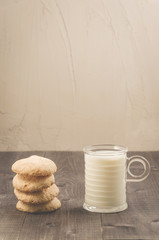 cookies and glass of milk/cookies and glass of milk on a dark wooden table. Selective focus