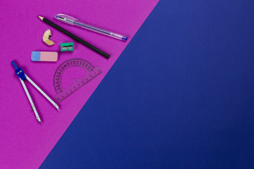 A photo of stationery set: pencil, rubber, sharpener, compass, protractor, ruler,  and etc. on the...