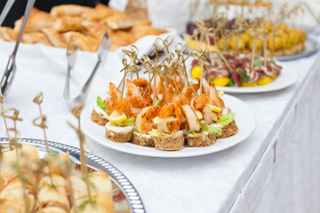 Event with various appetizers on a table with a white tablecloth