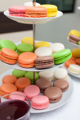 Stand with French macarons of different colors on the holiday