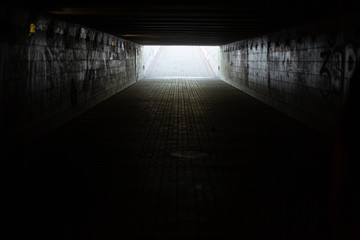 A long concrete tunnel, underground pedestrian crossing in the city. Underpass.