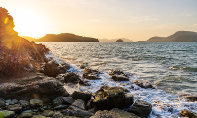 Seascape with sky and mountain in evening light over light the sun