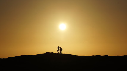 Silhouette Couple Walking against an Golden Sunset