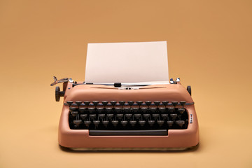 Retro typewriter coral color in studio, studio shoot.