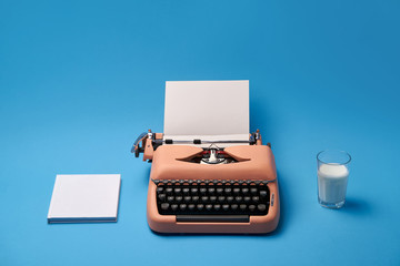 Composition with typewriter, book and glass. Studio shoot.