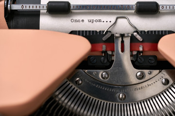 Vintage typewriter coral color in studio, close up.