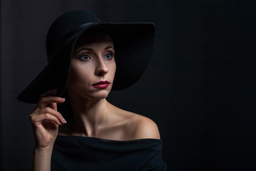 beautiful portrait of a woman in a black hat