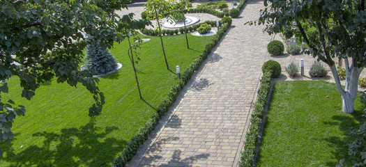 Cobbled concrete paving slab track in a beautifully manicured garden