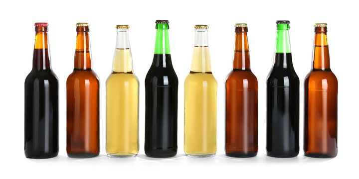Bottles with different beer on white background