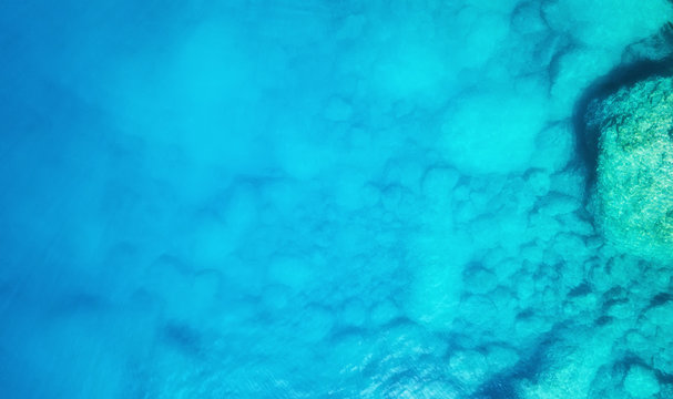 Aerial view at the sea. Turquoise water from air as a background from air. Natural seascape at the summer time. Seascape from drone