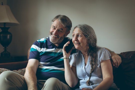 Senior woman talking on mobile phone at home