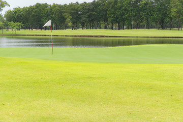 Beautiful golf court and garden, pond or Marsh on white Flag on a hole in one.