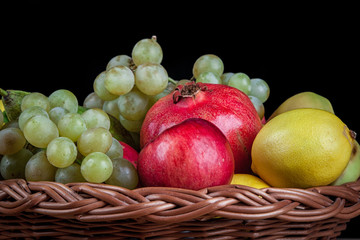 pomegranates and other fruit in the basket