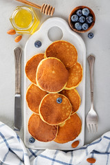 Classic american pancakes with fresh berry and honey. top view.