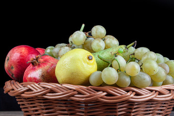 pomegranates and other fruit in the basket