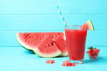 Summer watermelon drink in glass and sliced fruit on table