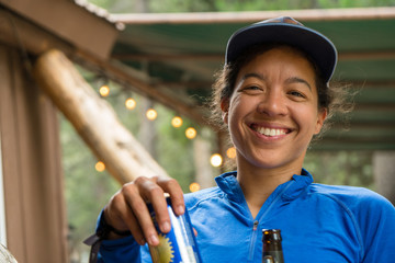 Smiling mixed race woman in the outdoors in a hunting lodge