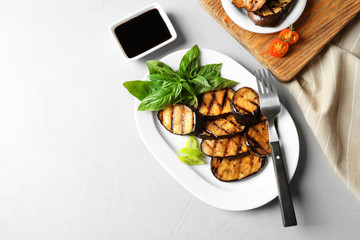 Plate with fried eggplant slices on table, top view. Space for text