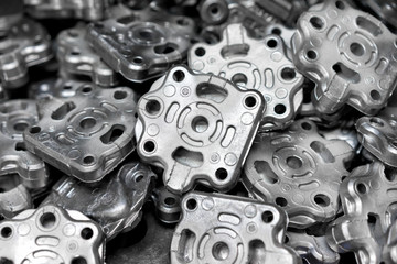 Pile of aluminum automotive parts, casting process in the automotive factory