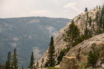 Fototapeta na wymiar Wide granite valleys under stormy skies in California's Sierra Nevada