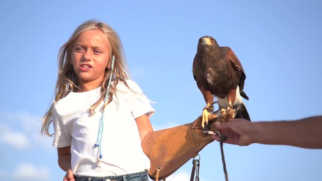 Blond girl blue eyes together hawk eagle.