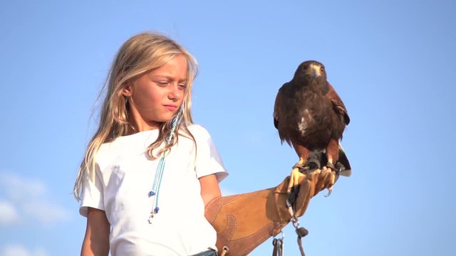 Blond girl blue eyes together hawk eagle.