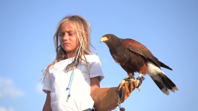 Blond girl blue eyes together hawk eagle.