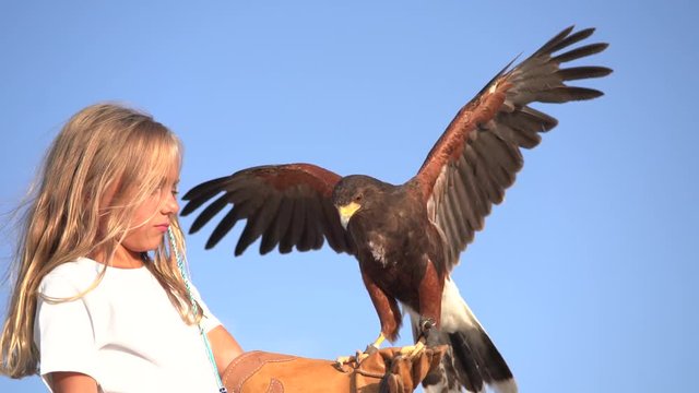 Blond girl blue eyes together hawk eagle.