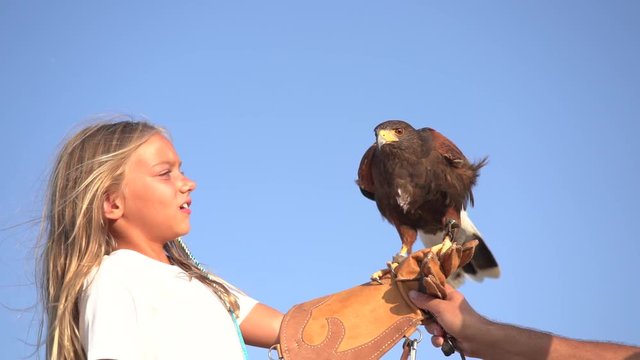 Blond girl blue eyes together hawk eagle.
