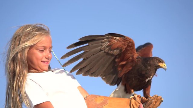 Blond girl blue eyes together hawk eagle.