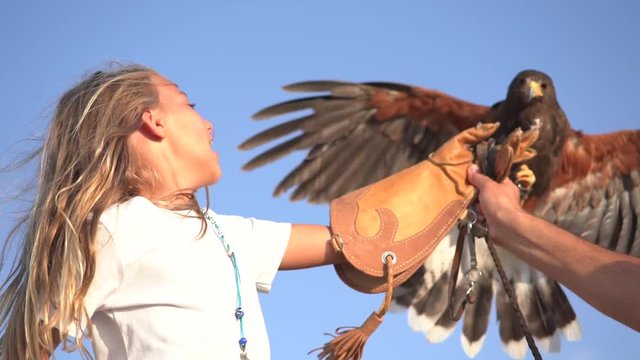 Blond girl blue eyes together hawk eagle.