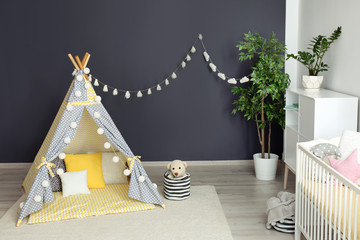 Cozy baby room interior with play tent and toys © New Africa