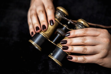 Ancient binoculars in female hands