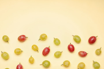 Fresh ripe juicy grapes on color background, top view. Space for text