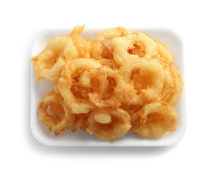 Plate with delicious golden breaded and deep fried crispy onion rings on white background, top view