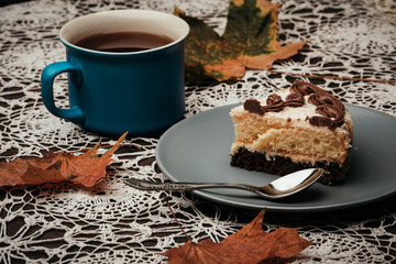 slice of cake with tea in autumn in the park