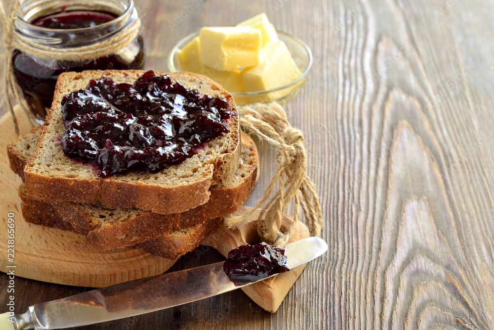 Wall mural Wholegrain toast with blackcurrant jam and butter,  copy space - Wall murals